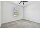 Carpeted bedroom featuring a modern ceiling fan and a window with blinds at 12710 Wheatgrass Ct, Parrish, FL 34219