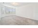 Bright and airy bedroom featuring plush carpeting and large windows that bring in plenty of natural light at 12710 Wheatgrass Ct, Parrish, FL 34219