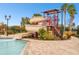 Community pool featuring a fun water slide and ample lounging area at 12710 Wheatgrass Ct, Parrish, FL 34219