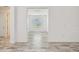 Bright and empty room featuring light-colored wood-look floors and white walls at 12710 Wheatgrass Ct, Parrish, FL 34219