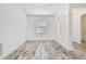Empty room with light-colored tile floors, white walls and natural light at 12710 Wheatgrass Ct, Parrish, FL 34219