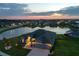 Exterior elevation of home on the water with meticulous landscaping, palm trees, and manicured lawn at 12710 Wheatgrass Ct, Parrish, FL 34219
