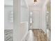 Bright foyer with wood-look tile flooring and a view of the front door at 12710 Wheatgrass Ct, Parrish, FL 34219