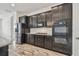Contemporary kitchen with stainless steel appliances and sleek dark cabinetry at 12710 Wheatgrass Ct, Parrish, FL 34219