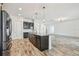 Open-concept kitchen with island, stainless steel appliances, and breakfast bar at 12710 Wheatgrass Ct, Parrish, FL 34219