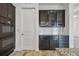 This kitchen features dark cabinetry, tile backsplash, and stainless steel appliances at 12710 Wheatgrass Ct, Parrish, FL 34219