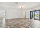 Open living room boasts tile floors, modern lighting, and access to the outdoor pool area at 12710 Wheatgrass Ct, Parrish, FL 34219
