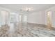 Spacious living room features tile floors, recessed lighting, and white walls at 12710 Wheatgrass Ct, Parrish, FL 34219