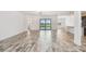 Expansive living area featuring tile floors and easy access to the outdoor living space and kitchen at 12710 Wheatgrass Ct, Parrish, FL 34219