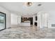Open-concept layout with tile floors connects the living area to the kitchen, perfect for entertaining at 12710 Wheatgrass Ct, Parrish, FL 34219