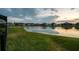Scenic pond view showcasing the neighborhood's tranquil setting at dusk at 12710 Wheatgrass Ct, Parrish, FL 34219