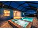 A backyard pool and jacuzzi are enclosed in a lanai with recessed lights at 12710 Wheatgrass Ct, Parrish, FL 34219