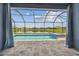 Screened-in outdoor pool and spa overlook a picturesque lake view at 12710 Wheatgrass Ct, Parrish, FL 34219