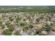 Aerial view of a residential community showcasing homes, green spaces, and mature trees at 1313 Key West Ct, Wesley Chapel, FL 33544