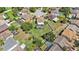 Aerial view of a home with a screened-in pool, surrounded by a large, well-kept backyard and neighboring houses at 1313 Key West Ct, Wesley Chapel, FL 33544