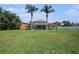 Wide backyard with well-maintained grass and a screened-in pool, great for relaxation at 1313 Key West Ct, Wesley Chapel, FL 33544