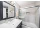 Modern bathroom featuring a sleek vanity, a glass-enclosed shower over tub, and elegant gray tiling at 1313 Key West Ct, Wesley Chapel, FL 33544