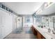 Large bathroom features a soaking tub, a separate glass shower, double vanity, and bright lighting at 1313 Key West Ct, Wesley Chapel, FL 33544