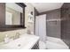 Modern bathroom featuring dark gray tiled walls, a shower-tub combo, and a vessel sink at 1313 Key West Ct, Wesley Chapel, FL 33544