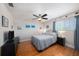 Comfortable bedroom with hardwood floors, a ceiling fan, and a large window that adds a bright, airy feel at 1313 Key West Ct, Wesley Chapel, FL 33544
