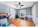 Guest bedroom featuring hardwood floors, a ceiling fan, and a sunlit window with natural light at 1313 Key West Ct, Wesley Chapel, FL 33544