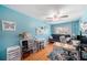 Bright bedroom with hardwood floors, a ceiling fan, and a cozy futon for relaxing and unwinding at 1313 Key West Ct, Wesley Chapel, FL 33544