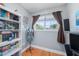 Cozy bedroom featuring hardwood floors, a window for natural light, and a decorative mannequin display at 1313 Key West Ct, Wesley Chapel, FL 33544