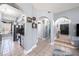 Hallway featuring tiled floors, decorative arches, and stylish decor leading to the entryway at 1313 Key West Ct, Wesley Chapel, FL 33544