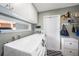 Bright laundry room featuring modern appliances, ample storage, and a convenient window for natural light at 1313 Key West Ct, Wesley Chapel, FL 33544