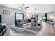Cozy living room featuring a comfortable sectional sofa and ample natural light from sliding glass doors at 1313 Key West Ct, Wesley Chapel, FL 33544