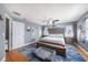 Spacious main bedroom features hardwood floors, a ceiling fan, and neutral colors that offer a tranquil space at 1313 Key West Ct, Wesley Chapel, FL 33544
