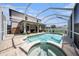Backyard featuring a beautiful pool, a jacuzzi and a screened-in enclosure for outdoor enjoyment at 1313 Key West Ct, Wesley Chapel, FL 33544