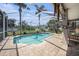 Inviting backyard pool featuring a screened-in enclosure and a pristine green lawn at 1313 Key West Ct, Wesley Chapel, FL 33544