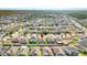 An aerial view showing the property in a well-planned community with a mix of residential homes at 15507 Caynor Ash Ln, Sun City Center, FL 33573