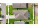 Aerial view of a home showcasing its roof, yard, driveway, and surrounding neighborhood at 15507 Caynor Ash Ln, Sun City Center, FL 33573