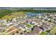 An aerial view of a charming neighborhood featuring well-maintained homes and scenic pond views at 15507 Caynor Ash Ln, Sun City Center, FL 33573