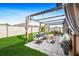 Backyard with outdoor seating under a pergola and a well-manicured lawn at 15507 Caynor Ash Ln, Sun City Center, FL 33573
