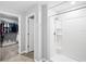 Neutral bathroom featuring a shower with white tiled walls and a glass door at 15507 Caynor Ash Ln, Sun City Center, FL 33573