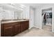 Bathroom featuring dual sinks, granite countertops, and decorative dark wood cabinets at 15507 Caynor Ash Ln, Sun City Center, FL 33573