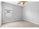 Simple bedroom with neutral walls, plush carpeting, and window offering natural light at 15507 Caynor Ash Ln, Sun City Center, FL 33573