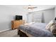 Comfortable bedroom with ample natural light, a dresser, and a TV for relaxed viewing at 15507 Caynor Ash Ln, Sun City Center, FL 33573