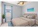 Stylishly decorated bedroom featuring a luxurious bed, coordinating artwork, and natural light from the window at 15507 Caynor Ash Ln, Sun City Center, FL 33573