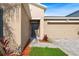 Home's entryway features a modern front door, green lawn, and an attached two-car garage at 15507 Caynor Ash Ln, Sun City Center, FL 33573