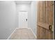 Bright hallway features a barn door, leading to the front door, and neutral tile flooring at 15507 Caynor Ash Ln, Sun City Center, FL 33573