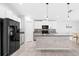 Modern kitchen featuring white cabinets, stainless steel appliances, and a center island with a sink at 15507 Caynor Ash Ln, Sun City Center, FL 33573