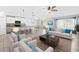 Open-concept living space with a modern kitchen, dining area, and a comfortable seating arrangement at 15507 Caynor Ash Ln, Sun City Center, FL 33573