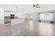 Bright and airy living room featuring tiled flooring, dining area, and an open flow into the kitchen area at 15507 Caynor Ash Ln, Sun City Center, FL 33573