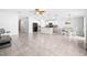 Expansive open-plan living area with tile floors, connecting the kitchen and dining spaces for seamless flow at 15507 Caynor Ash Ln, Sun City Center, FL 33573