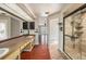 The renovated bathroom features double sinks, updated shower, and stylish fixtures at 16201 Country Crossing Dr, Tampa, FL 33624