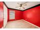 Inviting bedroom showcases red walls and a ceiling fan for added comfort at 16201 Country Crossing Dr, Tampa, FL 33624